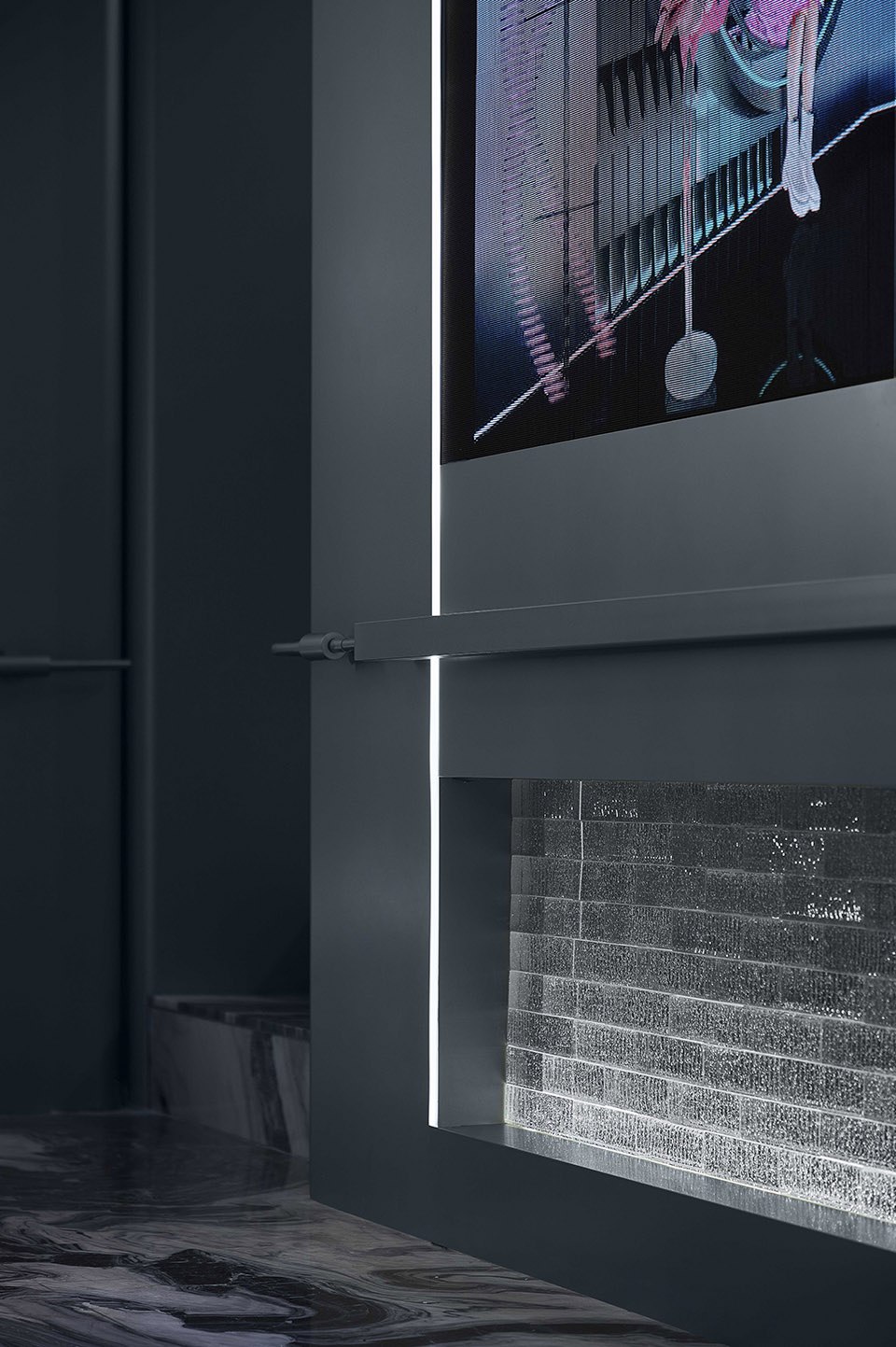 Wall surfaced in dark titanium PVD stainless steel for deep contrast