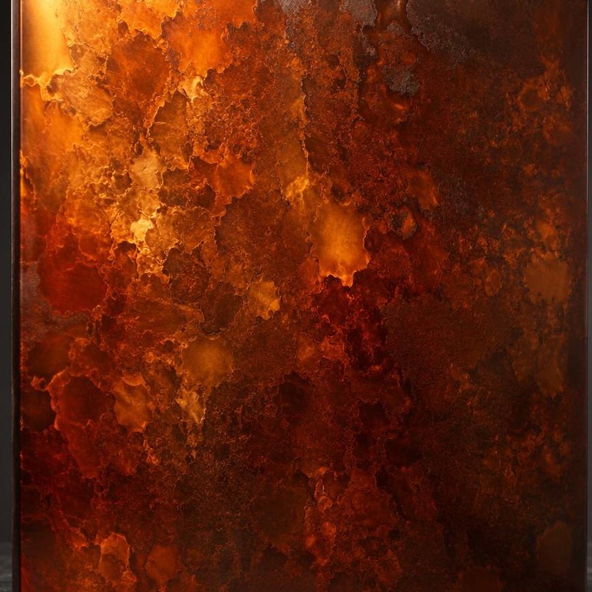 A close view of an amber-toned antique patina with deep tonal variation