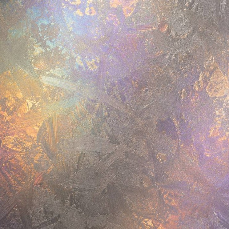An iridescent zinc-toned decorative stainless steel surface
