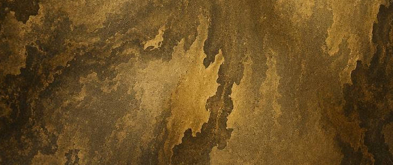 A burnished bronze antique stainless steel surface with mottled patina veining under warm side light