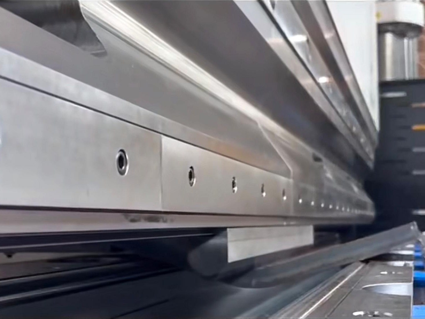 A stainless steel panel being formed on a press brake