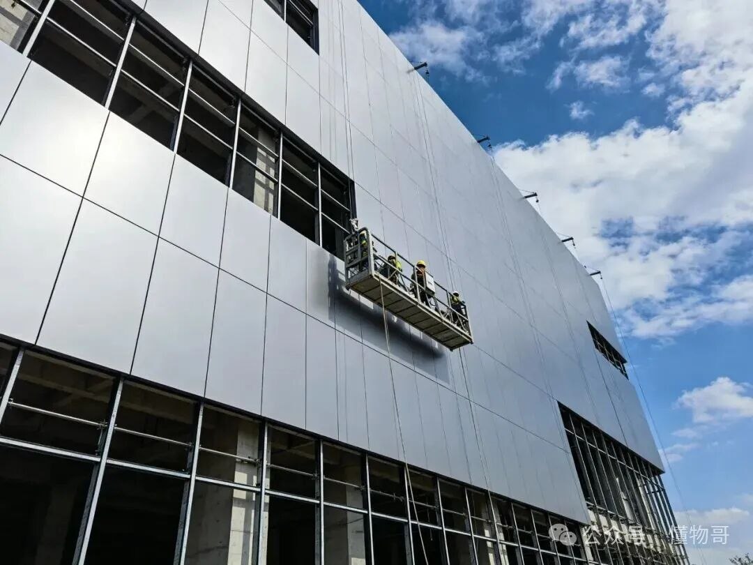 A completed building elevation clad in stainless steel panels