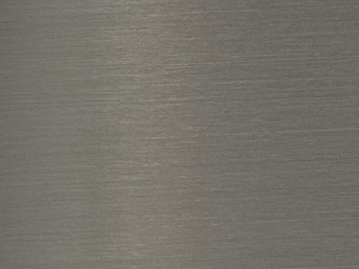A brushed stainless steel sample plate with a fine hairline grain