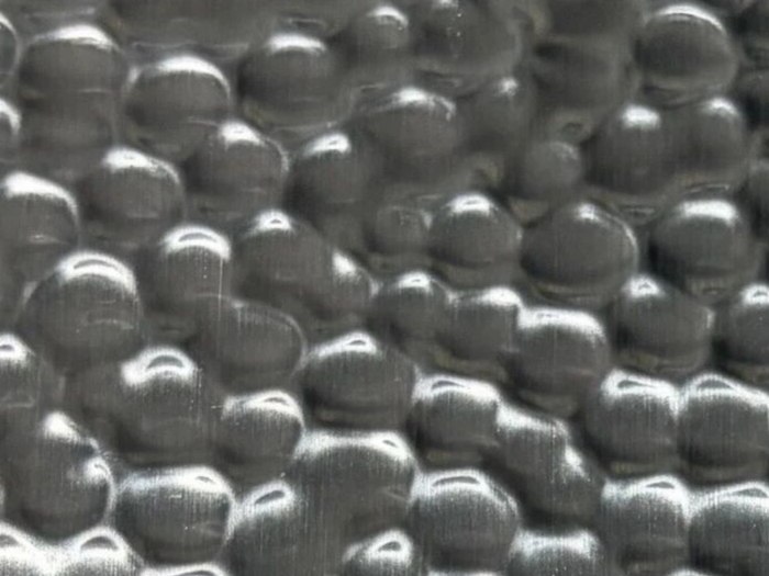Natural stainless steel with a hammered relief and no colour coating