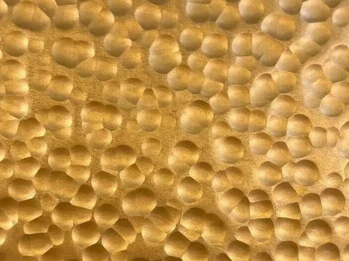Gold hammered stainless steel with a rich luminous metallic tone