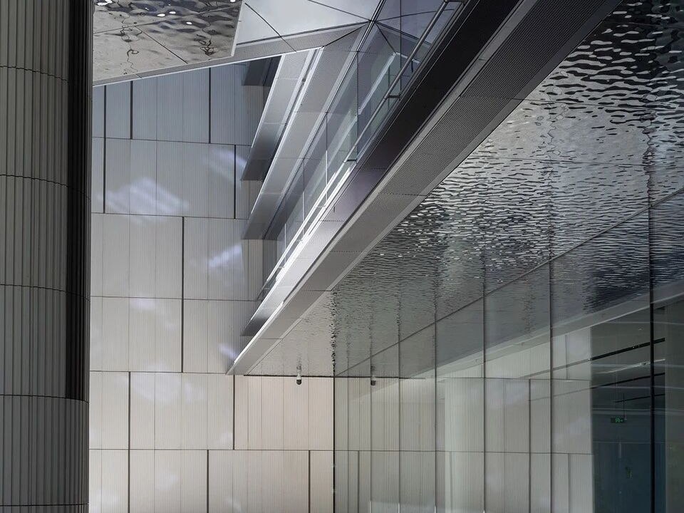 A water ripple stainless steel surface where reflections flow across the panel