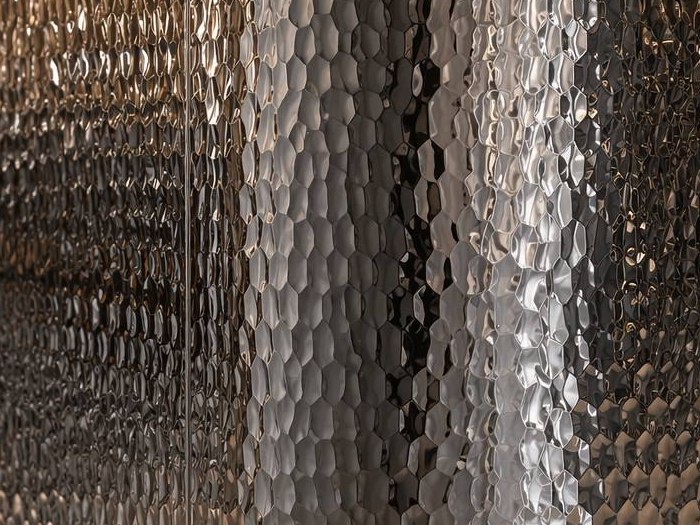 Macro view of champagne hammered stainless steel where raised and recessed areas create physical depth