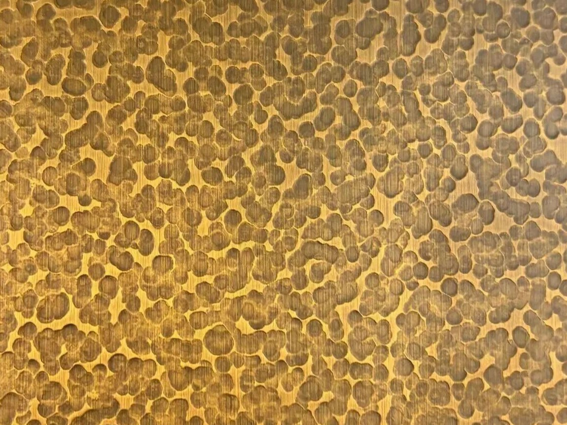 The same hammered surface across a larger panel, where individual relief reads as surface rhythm