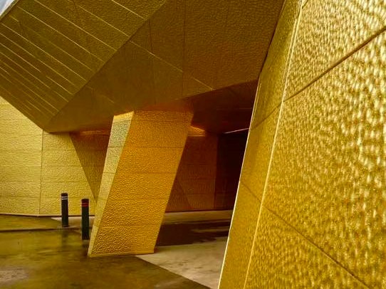 Hammered stainless steel cladding carried through to a finished architectural element