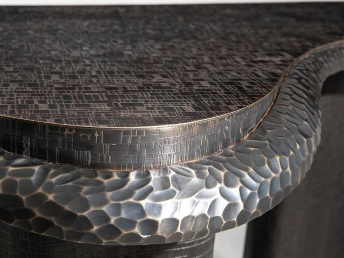 A bespoke curved hammered stainless steel screen where texture forms part of the geometry