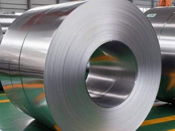 A plain stainless steel coil on the workshop floor before any texture is applied