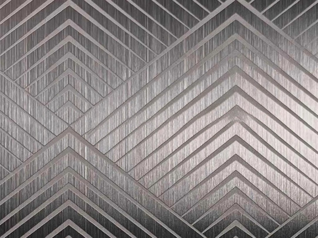 Etched stainless steel with repeated parallel lines creating controlled direction and visual order