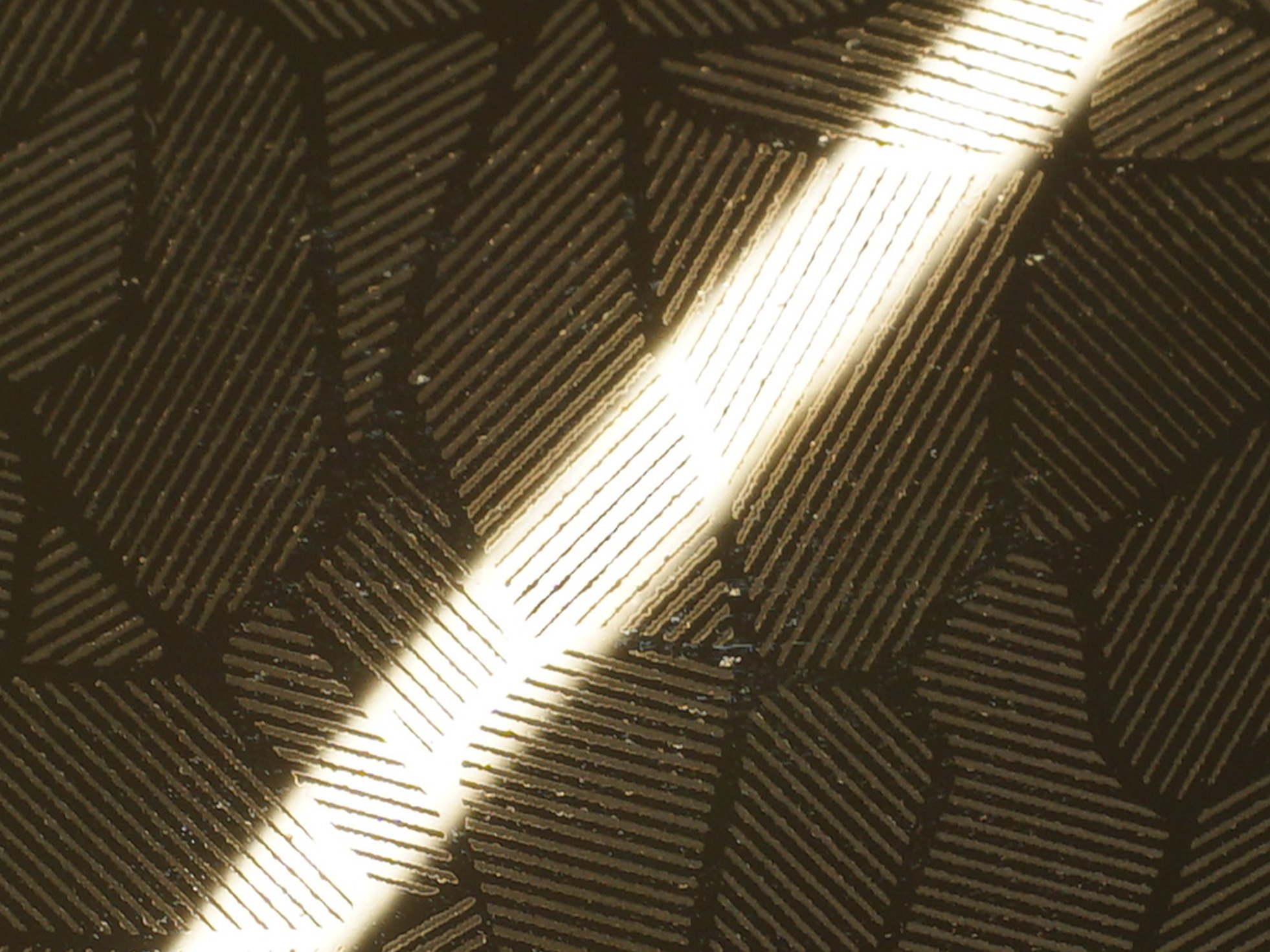 Etched stainless steel combining pattern, mirror surface character and a zirconium gold metallic tone