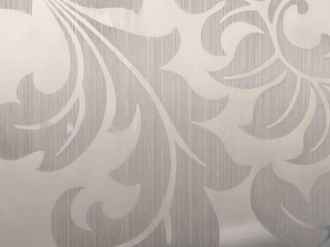 Natural uncoated etched stainless steel where the pattern alone carries the graphic expression