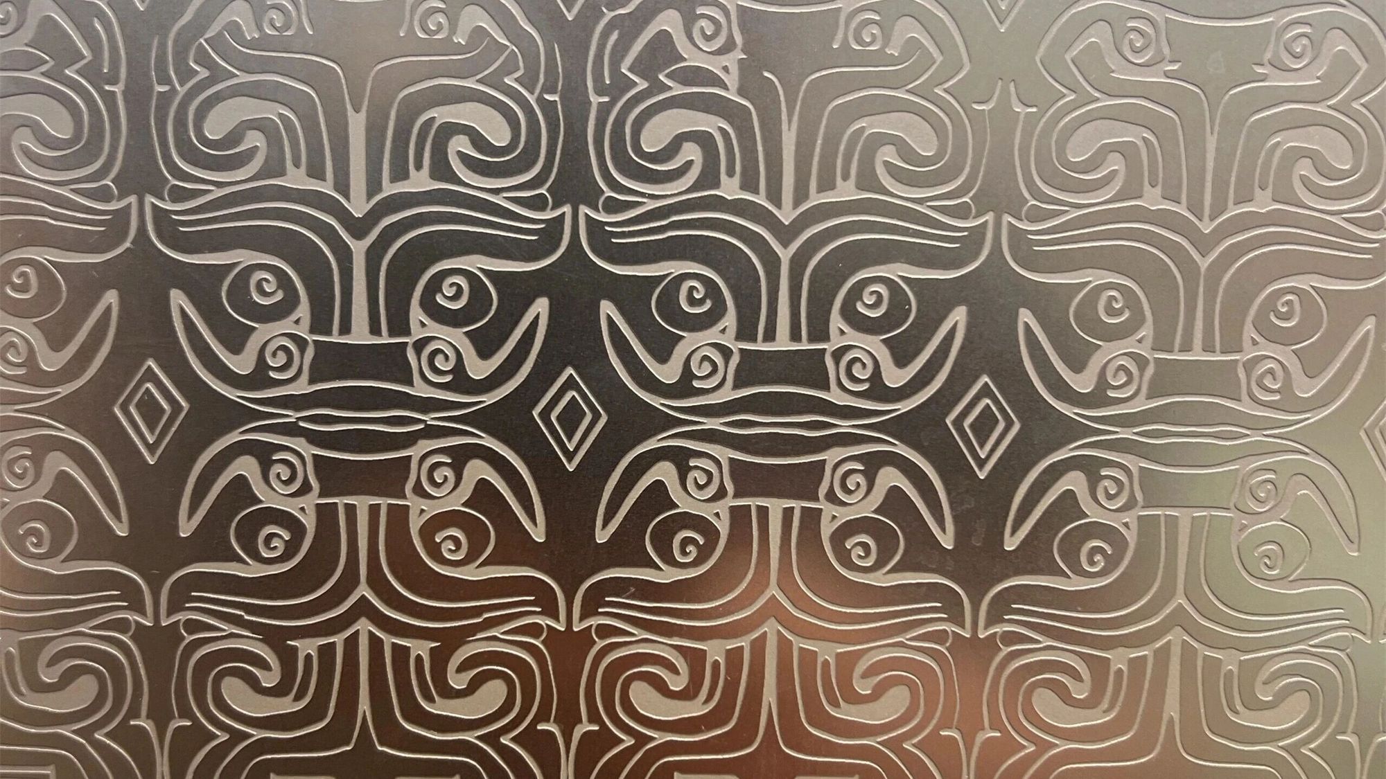Etched decorative stainless steel in bronze, an engineered graphic pattern etched into the surface