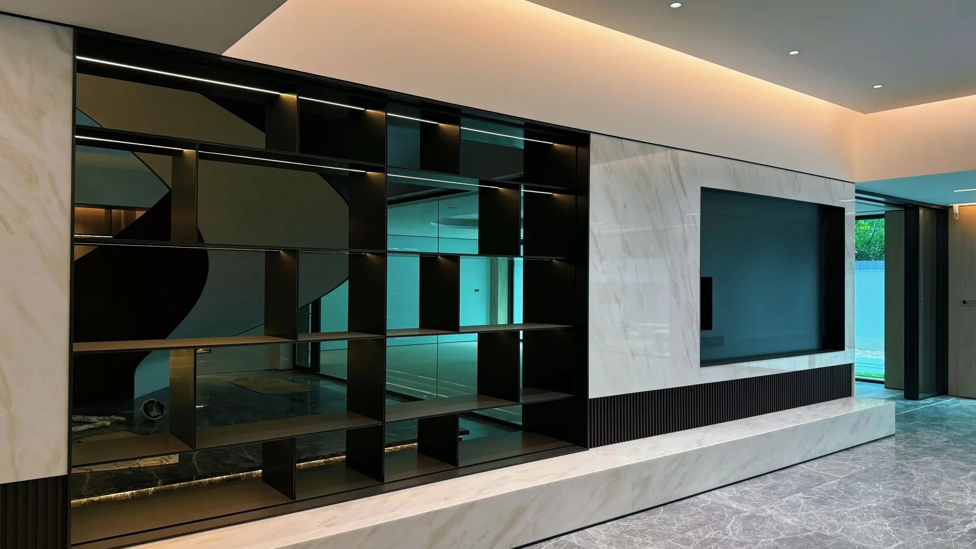 An interior in which a large printed stainless steel wall panel carries a stone-effect graphic