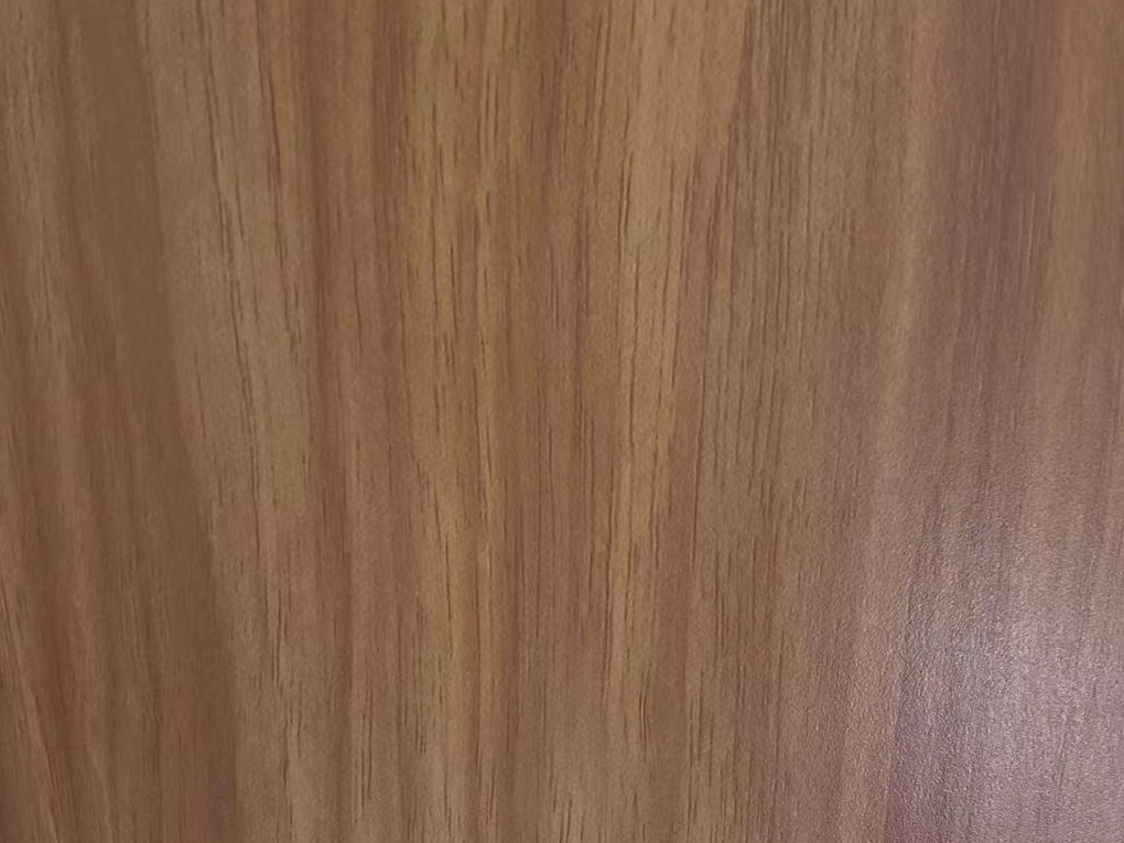 A timber-inspired printed stainless steel sample with warm walnut grain