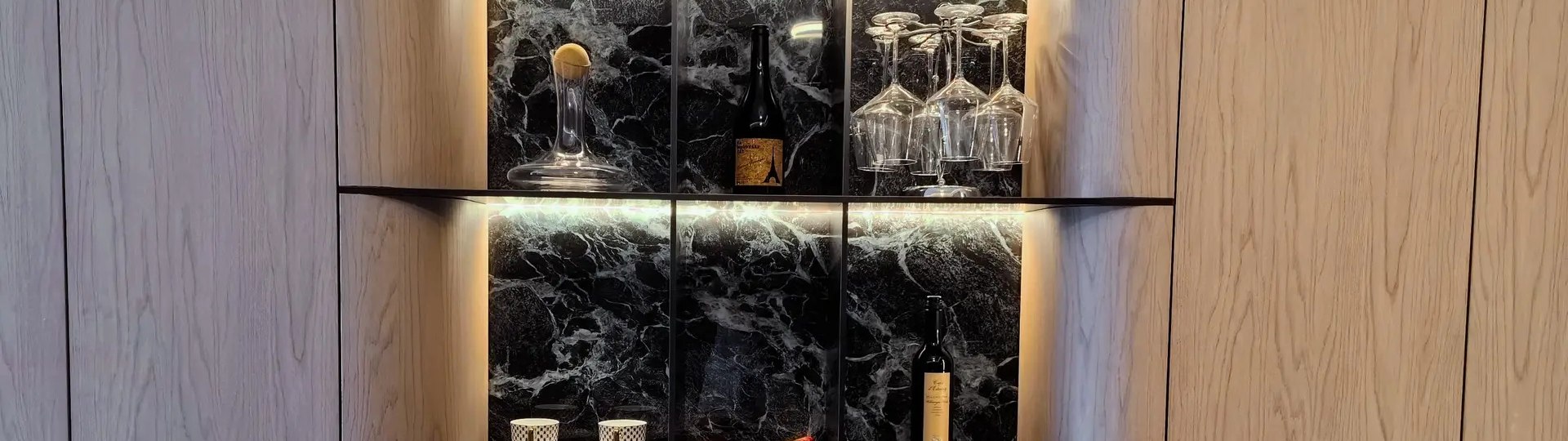 A printed stainless steel surface carried across a wall in a fitted interior