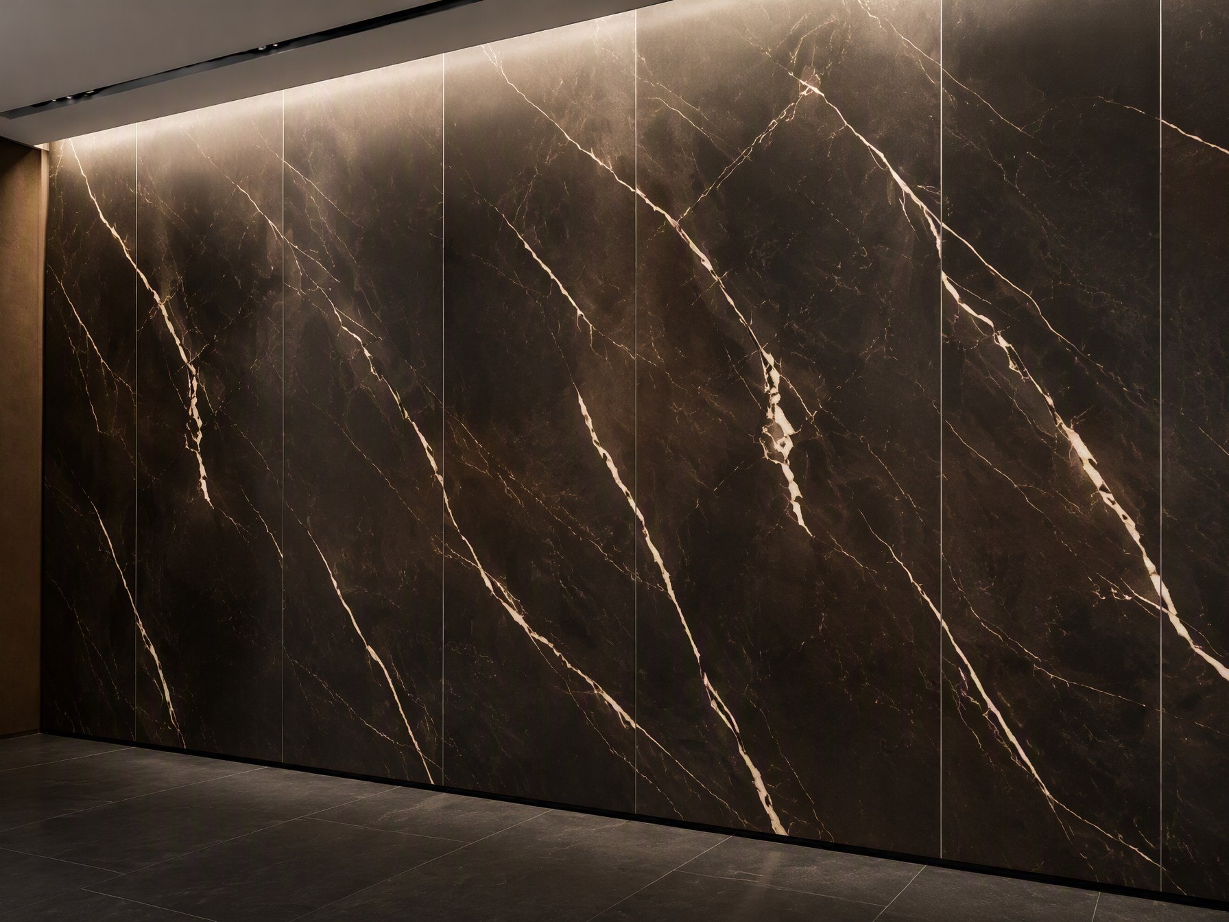 A printed stainless steel wall cladding panel in an interior, the graphic reading across the large wall plane