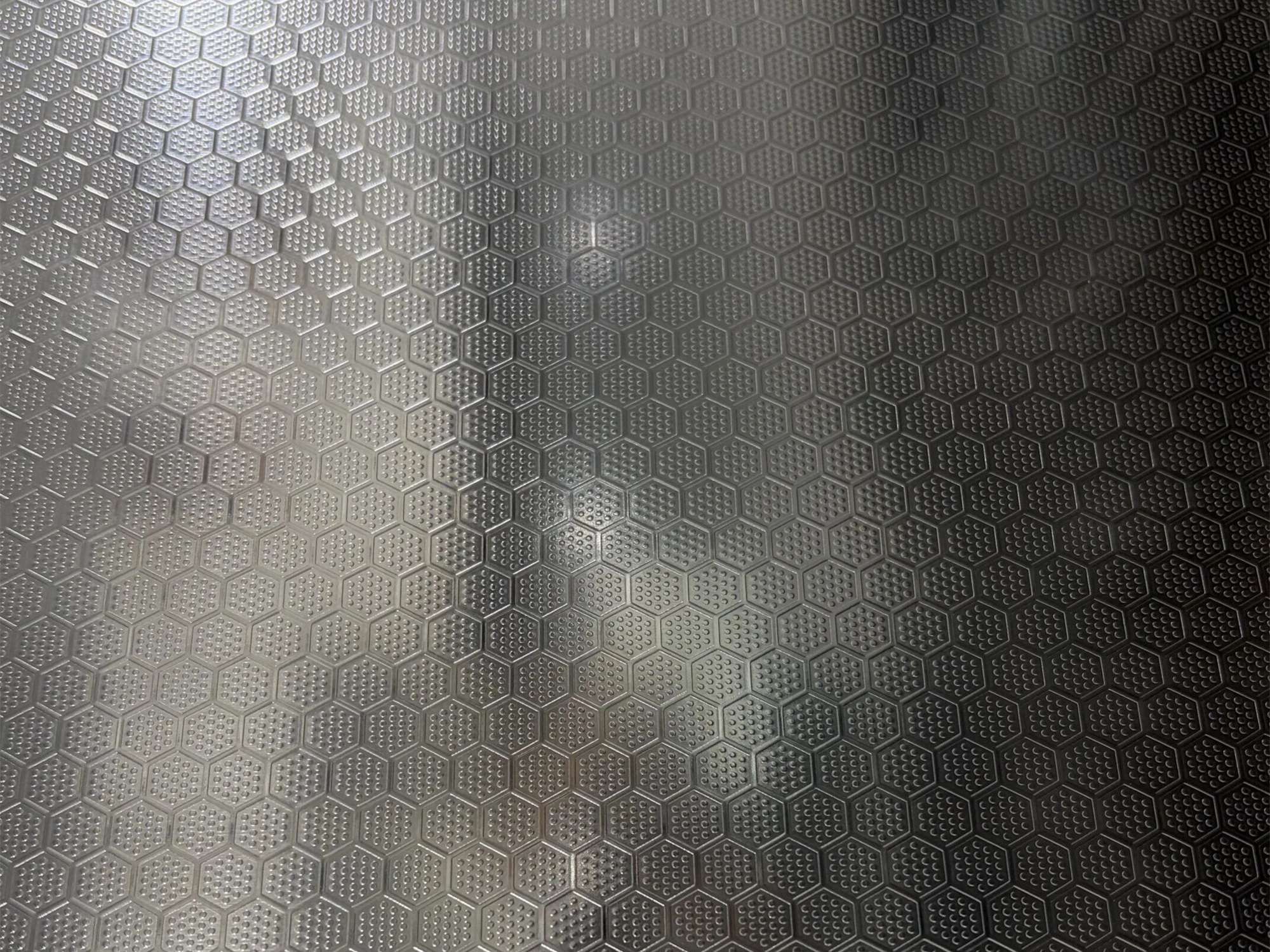 An embossed stainless steel sample where the pattern is formed into the sheet as relief