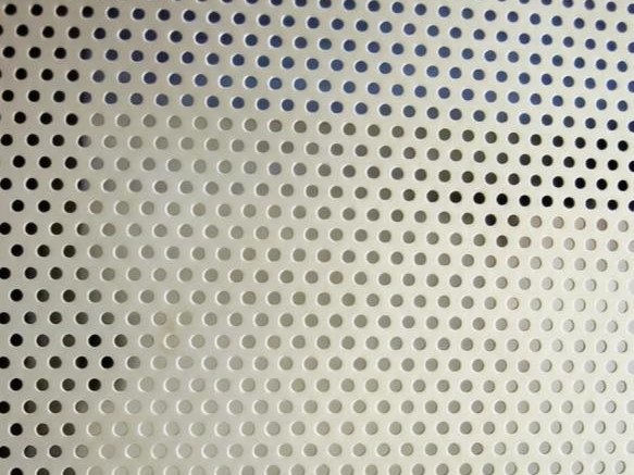 A perforated stainless steel sample where the pattern is cut through the sheet rather than printed on it