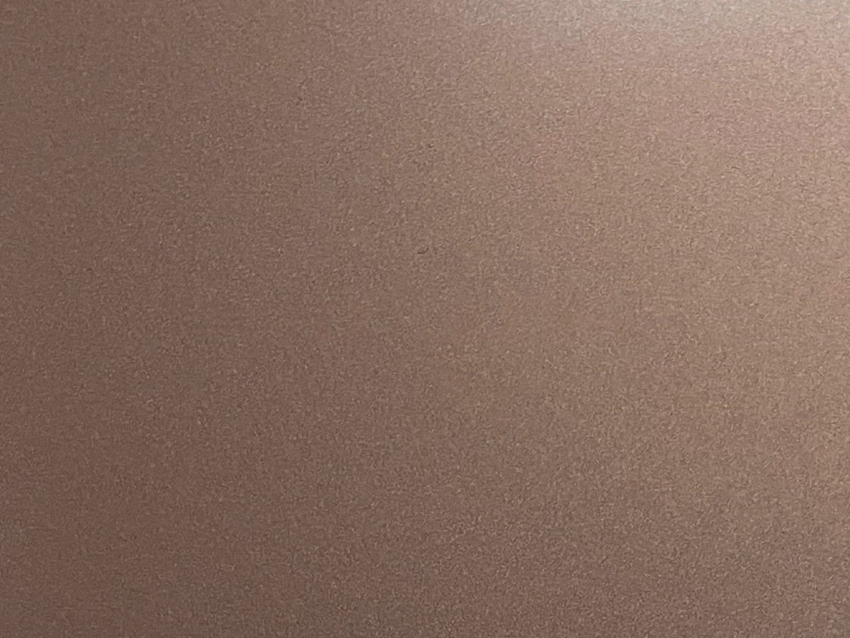Bronze sandblasted stainless steel surface with a matt diffuse grain