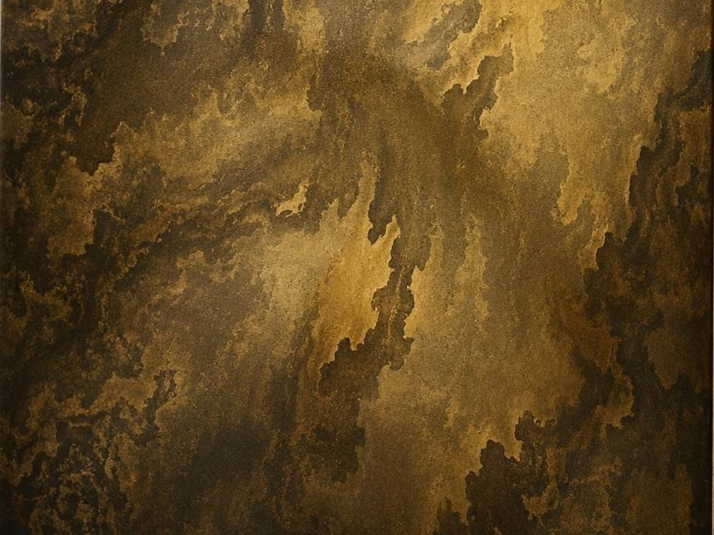 A burnished gold antique patina stainless steel surface with dark mottling