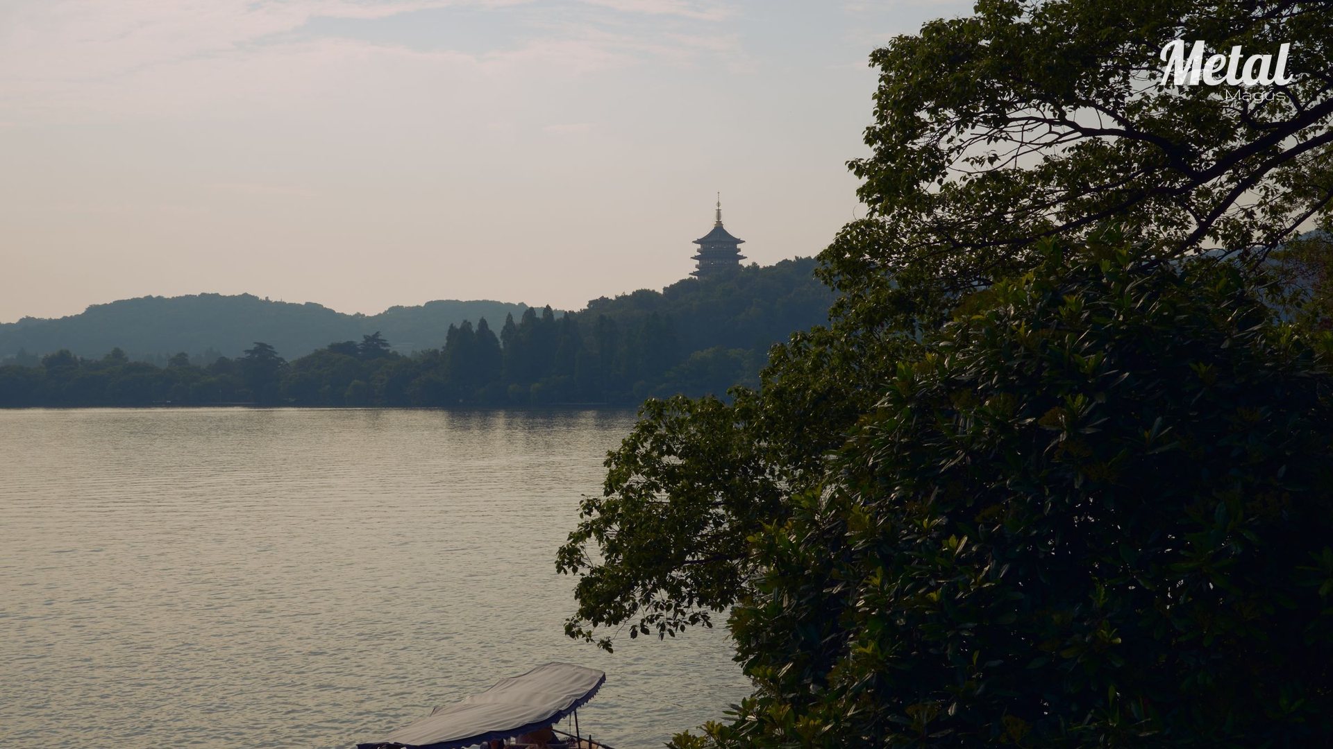 West Lake in Hangzhou in evening mist, seen from the lakeside