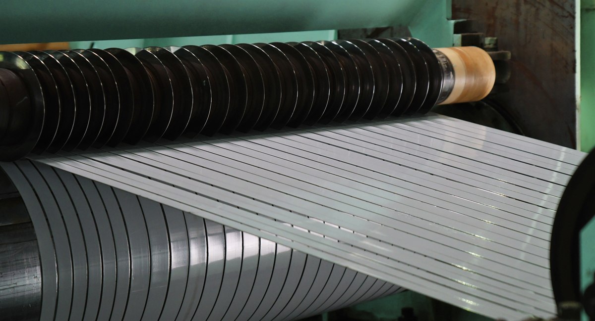 Slitting line cutting stainless steel coil into narrow strips at the cutter shaft
