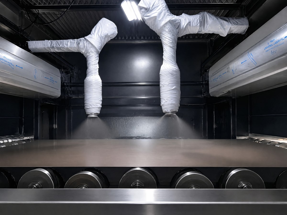 Two spray nozzles applying the nano anti-fingerprint coating inside the treatment booth