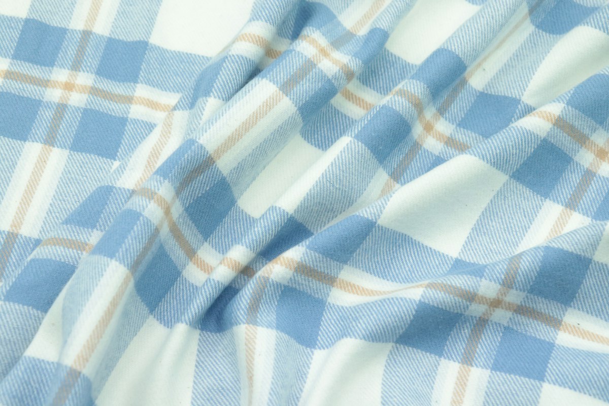 Blue and white checked sleepwear fabric inspected before custom pajama production