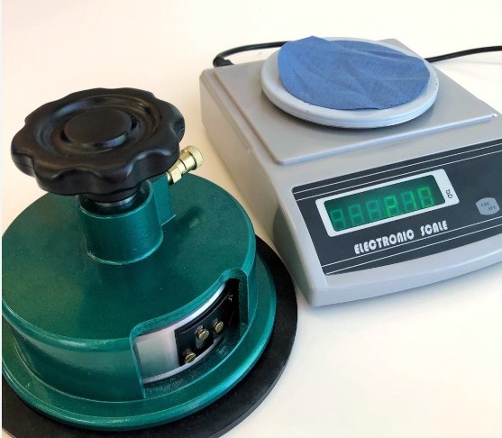 Fabric weight checked with a circular sample cutter and an electronic scale at a Chinese sleepwear factory