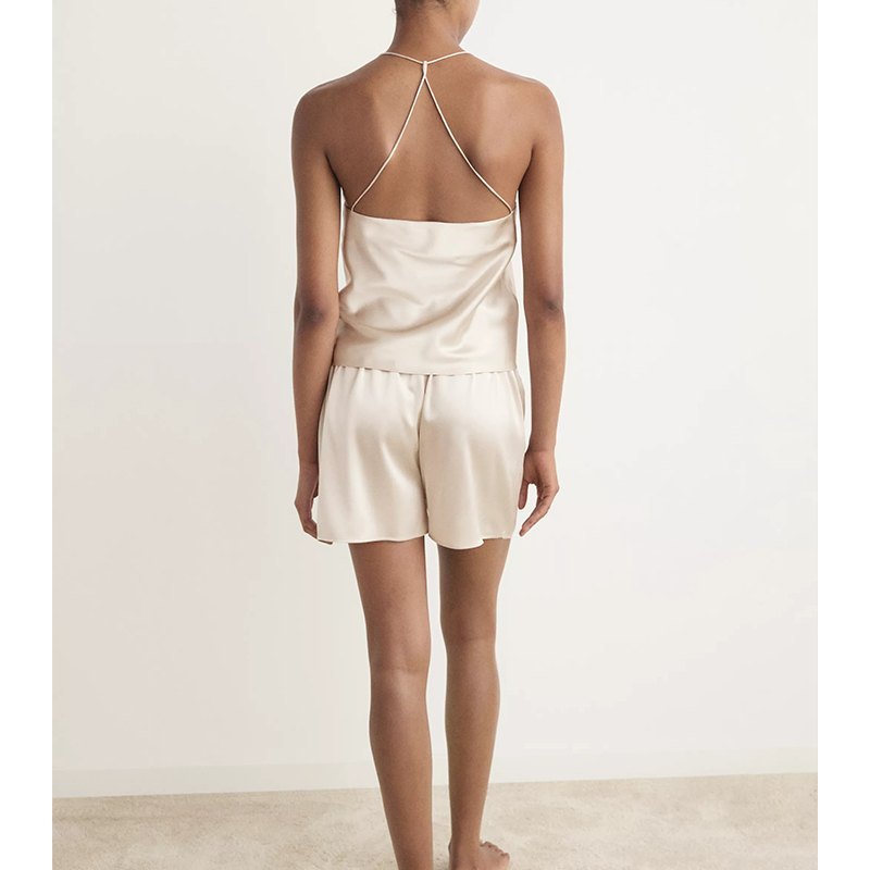 T-back strap detail on a beige satin camisole and shorts sleepwear set