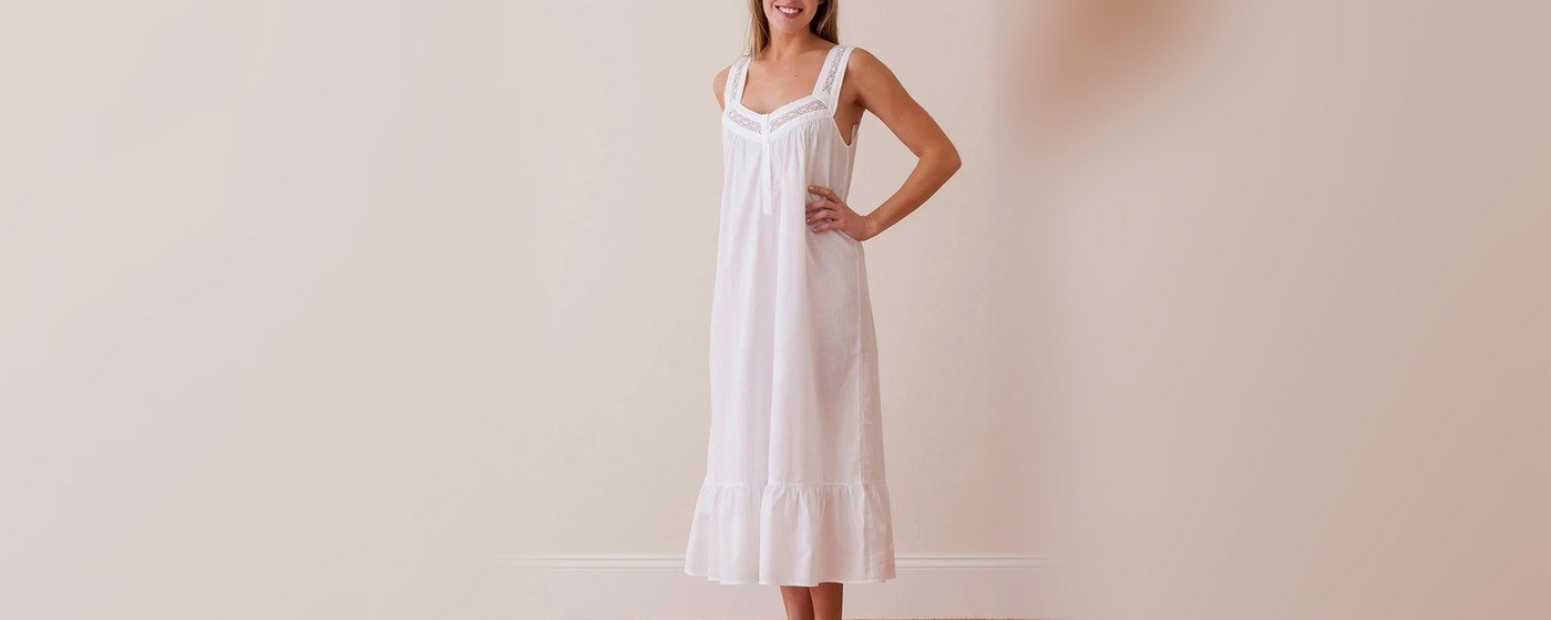 White cotton sleeveless nightgown with lace trim neckline and gathered ruffle hem for private label sleepwear