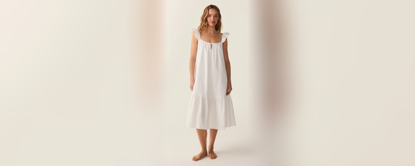 White dotted swiss cotton nightgown with ruffle flutter sleeves and a tiered ruffle hem for private label sleepwear