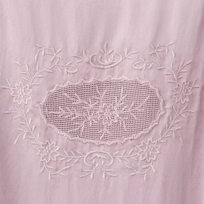 Close view of the embroidered floral lace yoke on a pink cotton slip nightgown