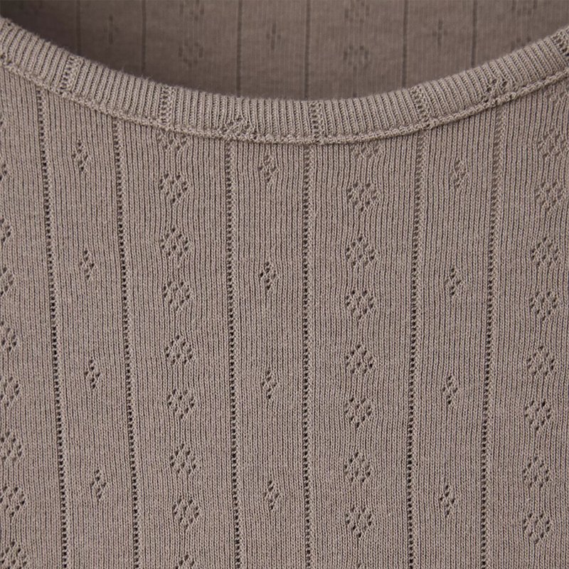 Close view of the pointelle open-knit pattern on a taupe knit lounge set