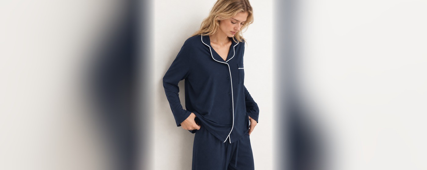 Navy modal knit pajama set with a white piped notch collar, button placket and chest pocket for private label sleepwear