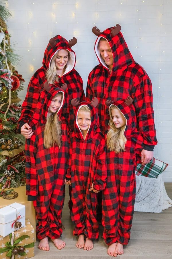 Matching red plaid onesie pajamas with hoods and reindeer antlers for the whole family