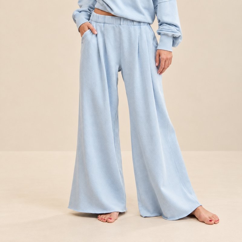 Close view of the elasticated tie waist and wide leg on an off-shoulder knit lounge set