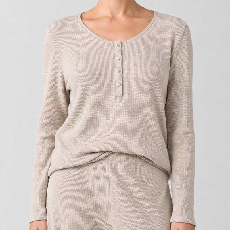 Close view of the waffle grid texture and button placket on a sand thermal knit lounge set