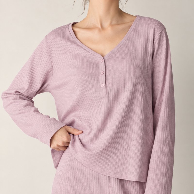 Close view of the fine vertical rib and V-neck button placket on a lilac knit lounge set