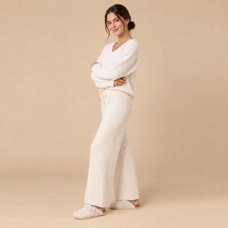 Close view of the chunky vertical rib and V-neckline on an ivory knit lounge set