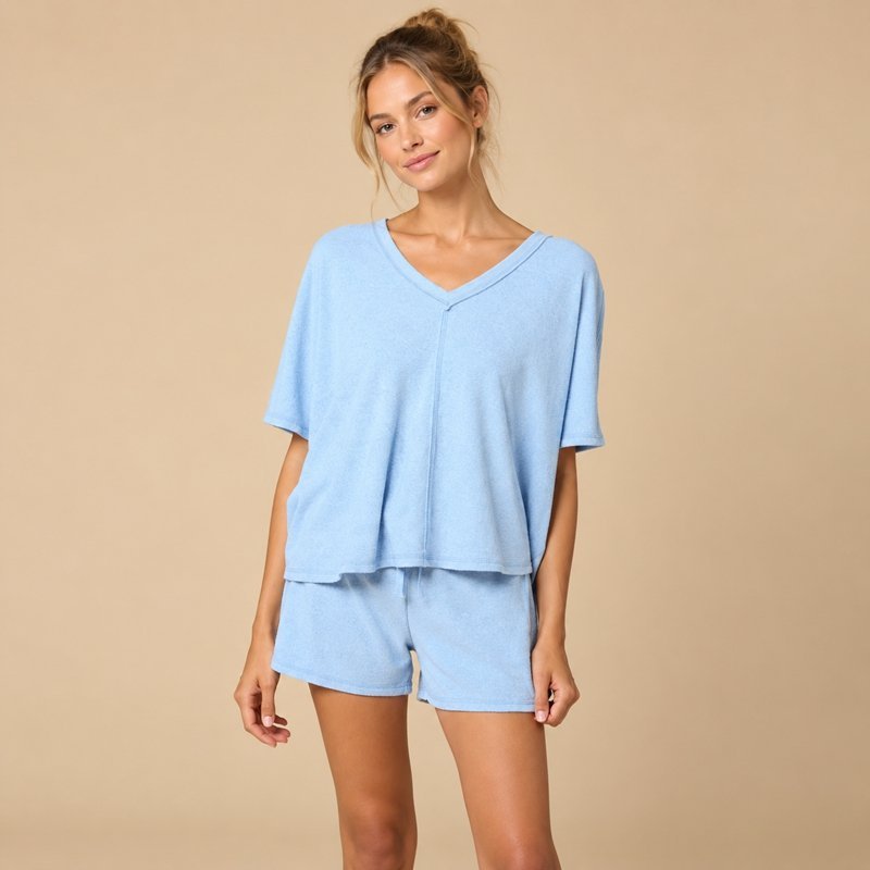Close view of the V-neckline and elasticated shorts on a cornflower blue oversized tee set