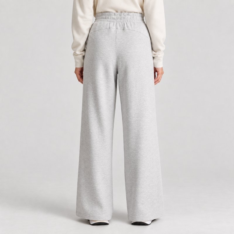 Close view of the drawstring waist and wide open hem on light grey lounge sweatpants