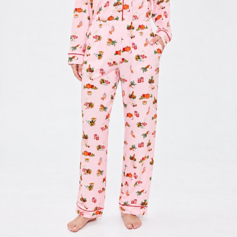 Close view of the harvest print motifs and deep red piping on a pink printed pajama set