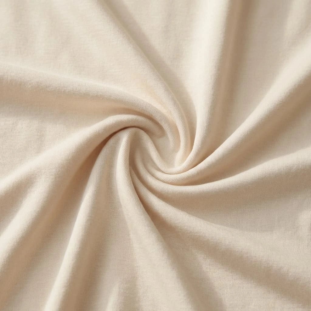 Soft cream bamboo viscose knit fabric with a smooth, fluid drape