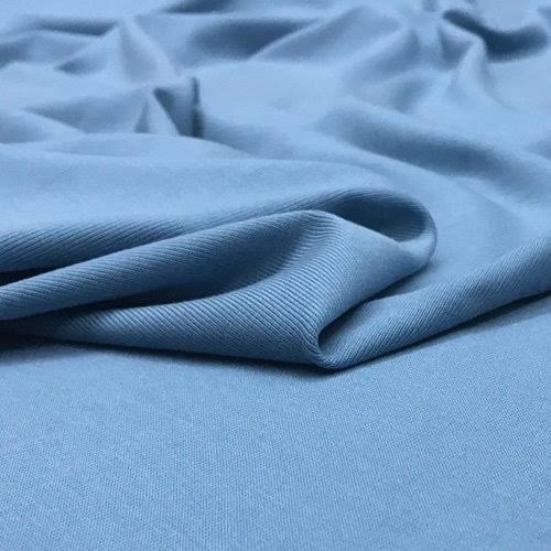 Blue bamboo lyocell knit fabric folded in smooth, soft folds