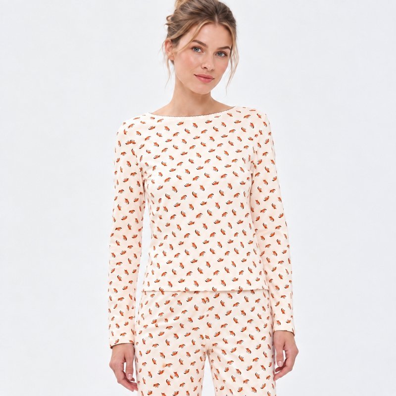 Close view of the coral fox print and boat neckline on a cream cotton jersey pajama set
