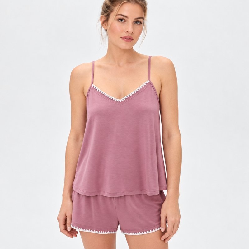Close view of the contrast ruffle trim on the neckline and hem of a mauve Tencel modal cami set